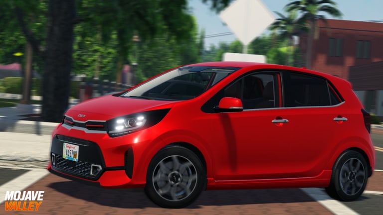 Red hatchback driving a tree-lined Mojave Valley street