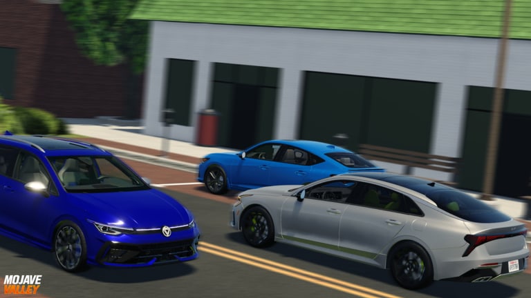 Three dealership cars parked on a Mojave Valley town street