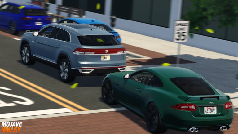 Crossover and coupe at a 35 mph Mojave Valley town corner